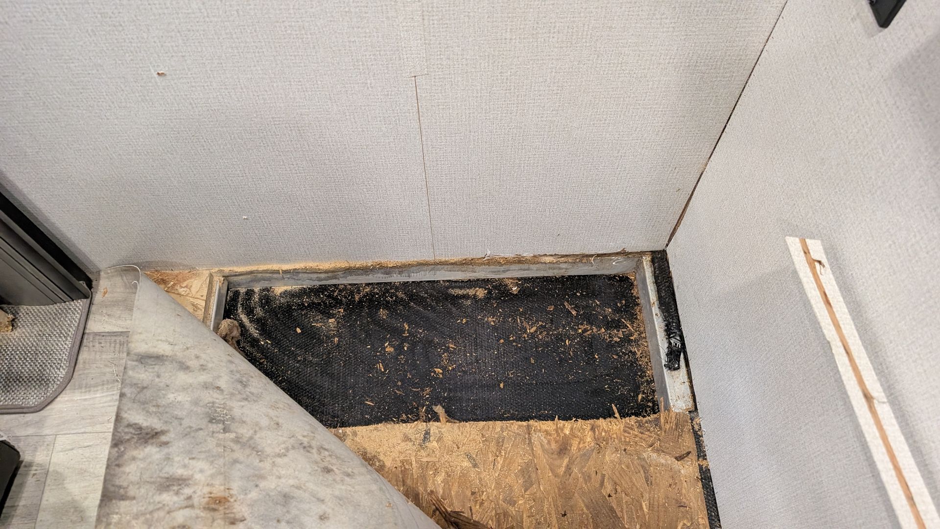 Rotted RV floor section cut away during repair