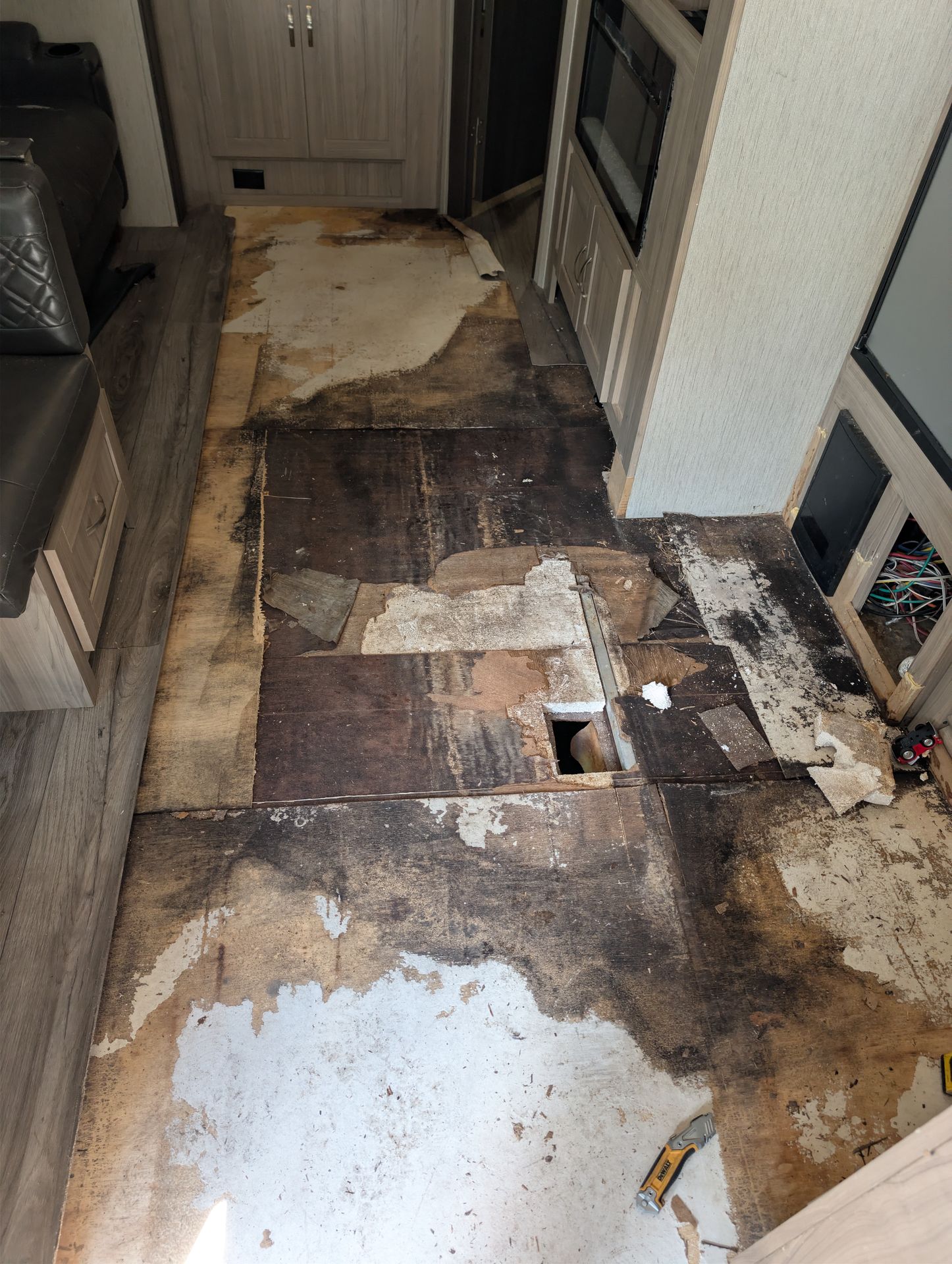 Rotted RV floor being removed down to the frame
