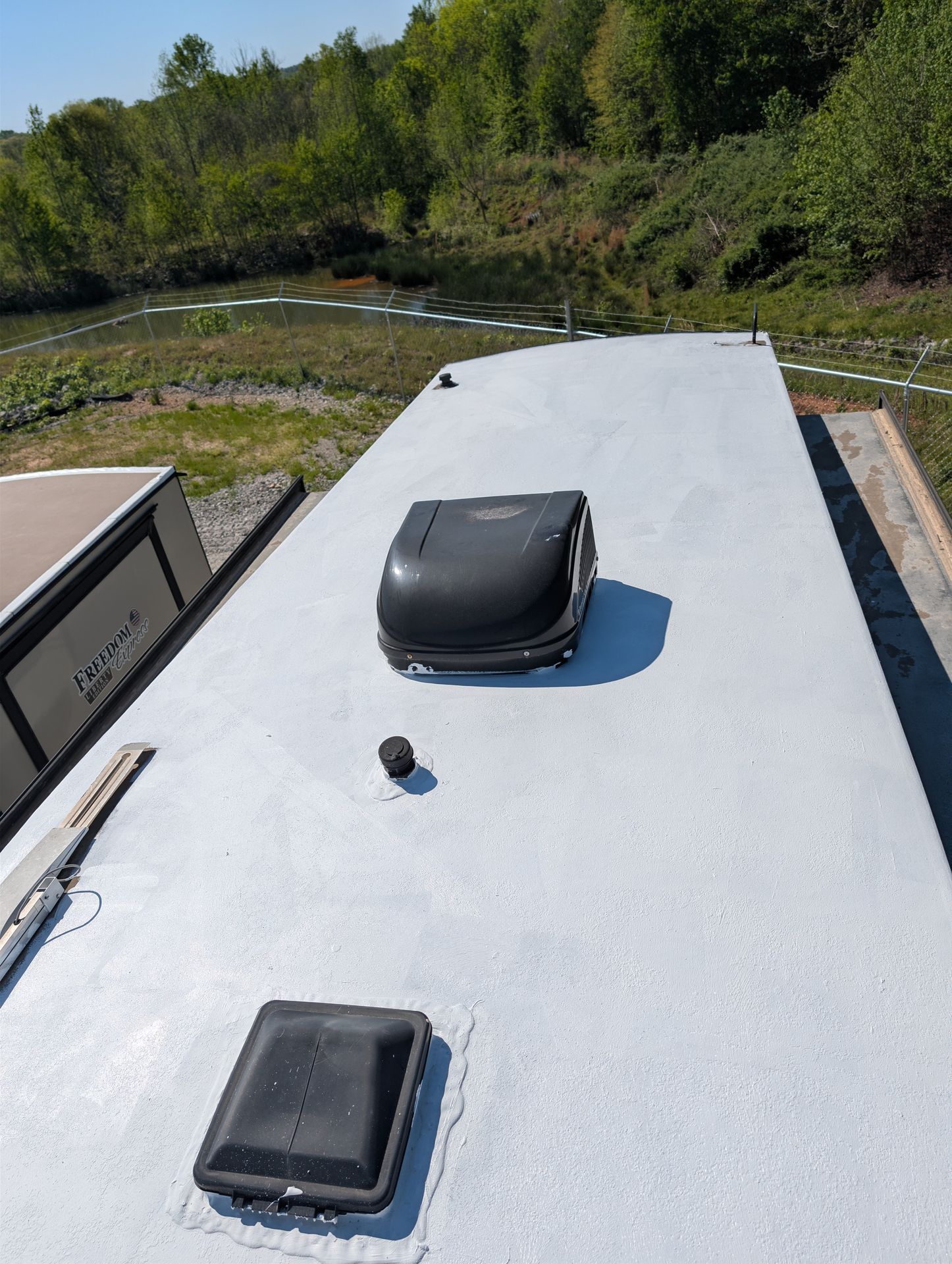 RV roof midway through a full protective coating