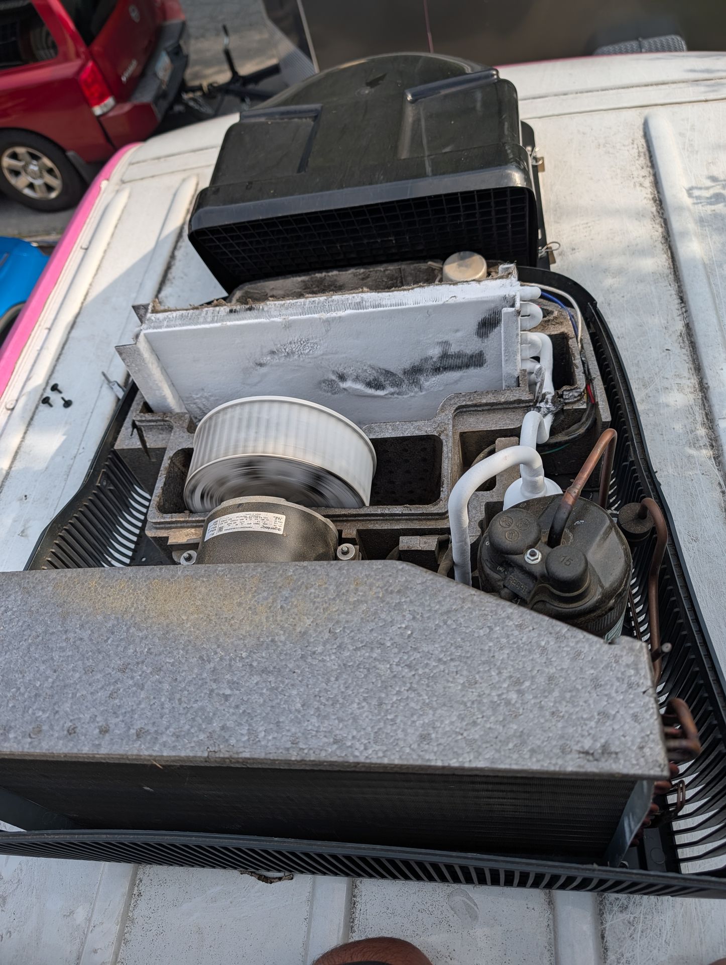 Amp draw being checked on an RV air conditioner with a clamp meter